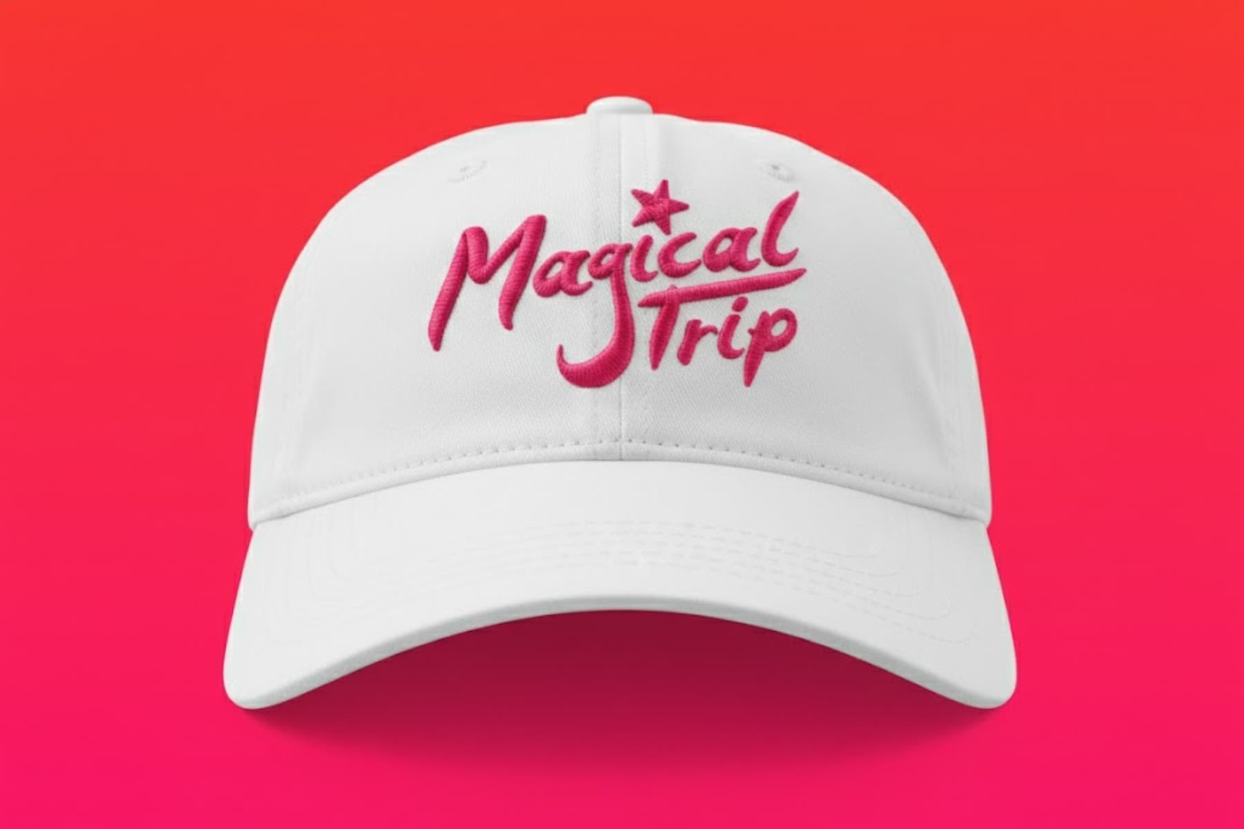 White cap embroidered with the Magical Trip script logo